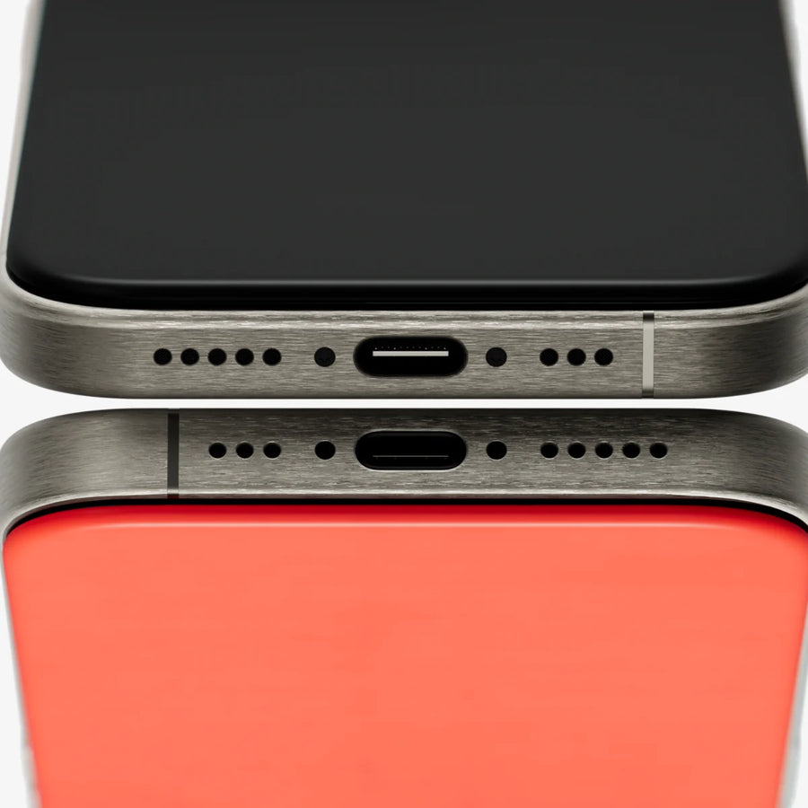 The bottom edges of two iPhones, showing the PhoneBack's port cutout lining up